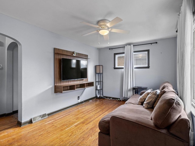 living room featuring ceiling fan and hardwood / wood-style flooring