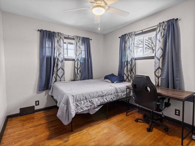 bedroom with ceiling fan and hardwood / wood-style flooring