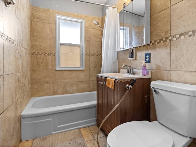 full bathroom featuring tile walls, tile patterned flooring, a wealth of natural light, and vanity