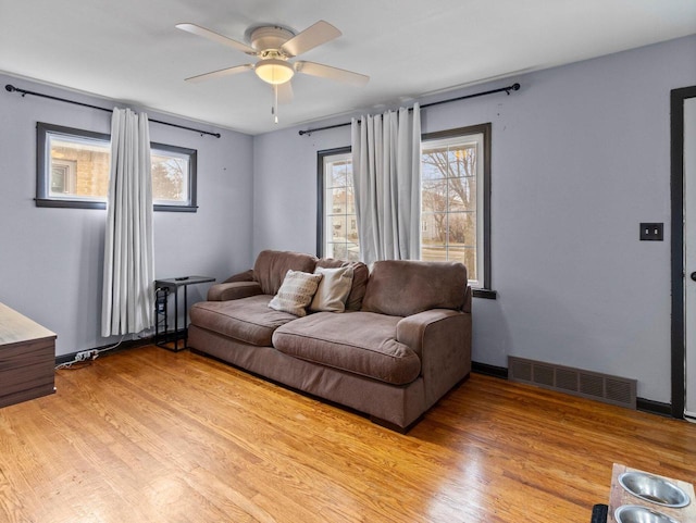 living room featuring ceiling fan and light wood-type flooring