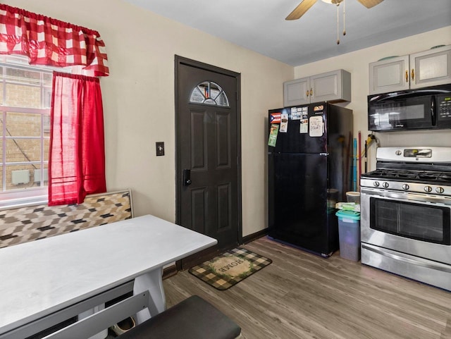 kitchen with dark hardwood / wood-style flooring, ceiling fan, black appliances, and gray cabinetry