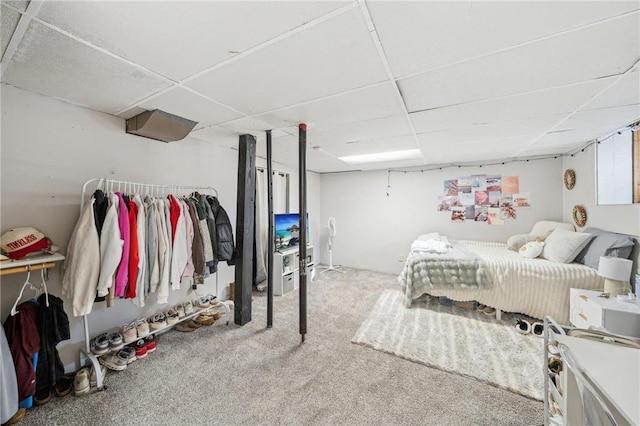 carpeted bedroom featuring a paneled ceiling