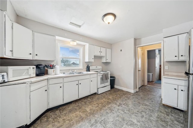 kitchen featuring white cabinets, sink, and white appliances