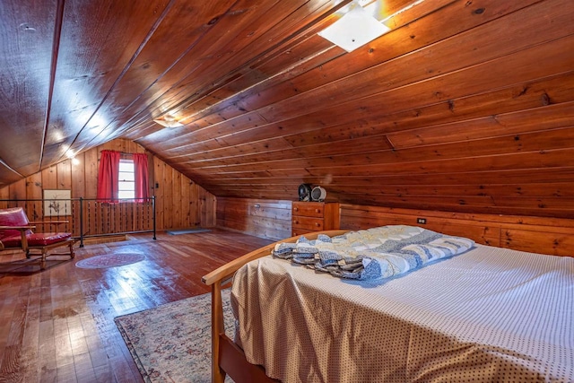 bedroom featuring vaulted ceiling, wooden walls, wood ceiling, and hardwood / wood-style floors