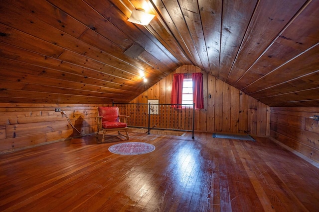 bonus room featuring hardwood / wood-style floors, wooden ceiling, vaulted ceiling, and wood walls