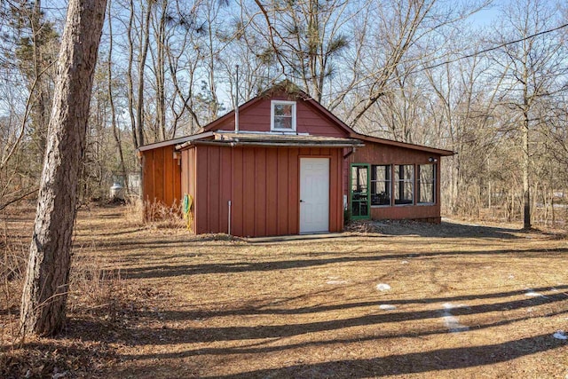 view of outdoor structure with a sunroom