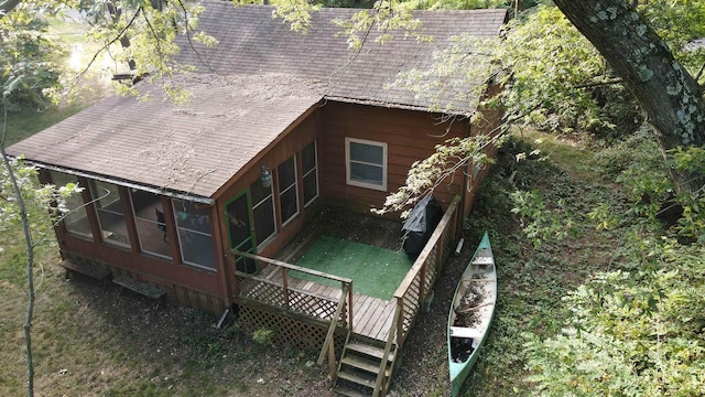 rear view of house with a deck and a sunroom