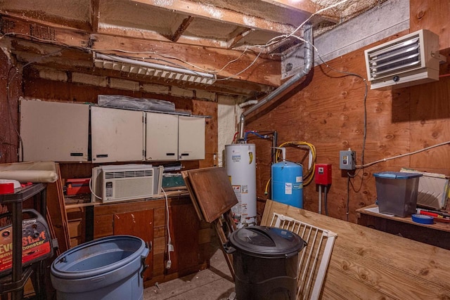 basement with a wall mounted air conditioner and water heater