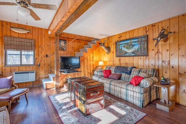 living room featuring a wall unit AC, wood walls, ceiling fan, and dark hardwood / wood-style floors