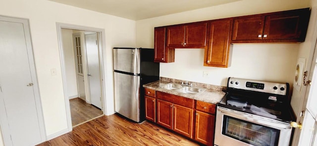 kitchen featuring sink, light hardwood / wood-style flooring, and appliances with stainless steel finishes