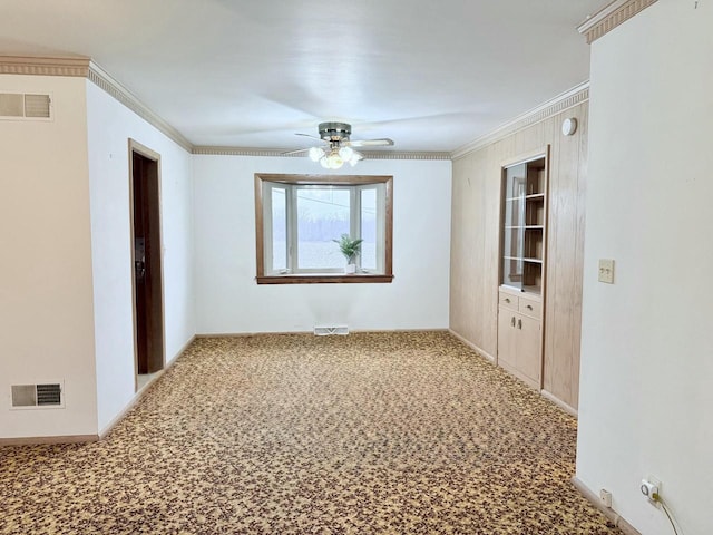 spare room with carpet floors, ceiling fan, and crown molding