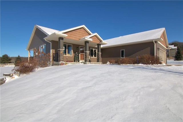 view of front of house with a porch and a garage