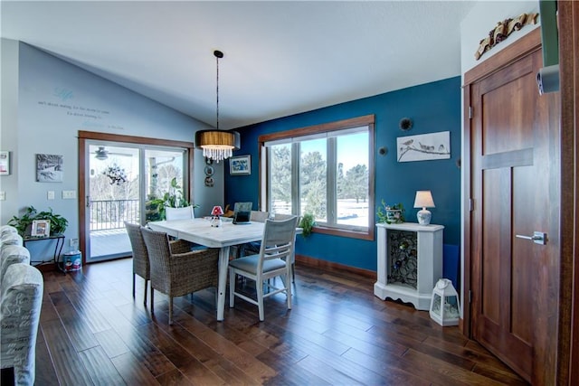 dining area featuring lofted ceiling, a notable chandelier, and dark hardwood / wood-style floors