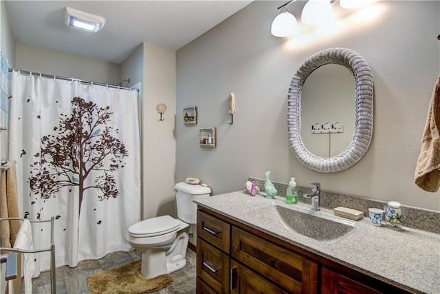 bathroom featuring toilet and vanity