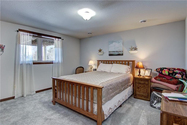 carpeted bedroom featuring a textured ceiling