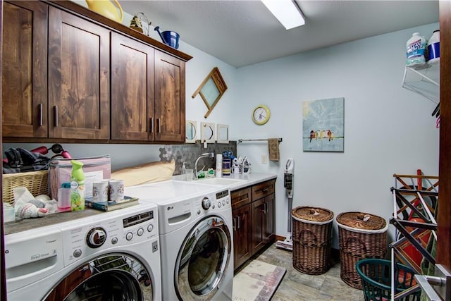 laundry room featuring sink, cabinets, and independent washer and dryer