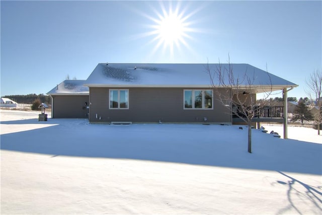 view of snow covered rear of property