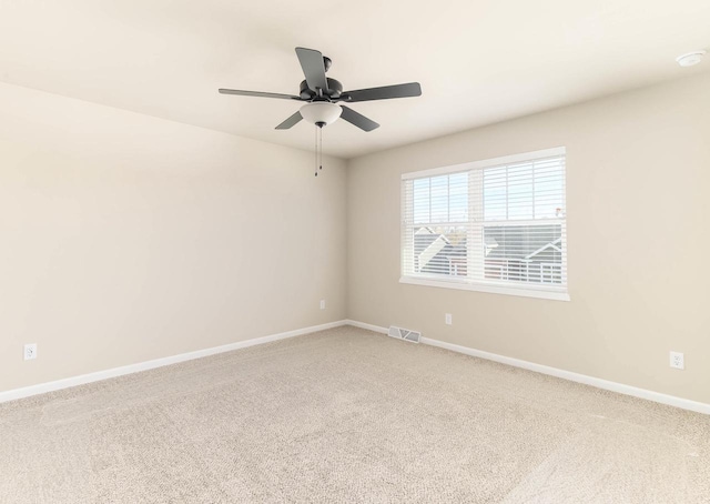 carpeted spare room with ceiling fan