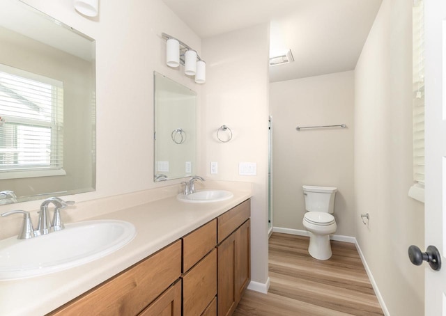 bathroom with vanity, hardwood / wood-style flooring, and toilet