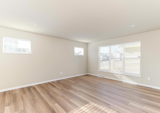 spare room with light hardwood / wood-style flooring