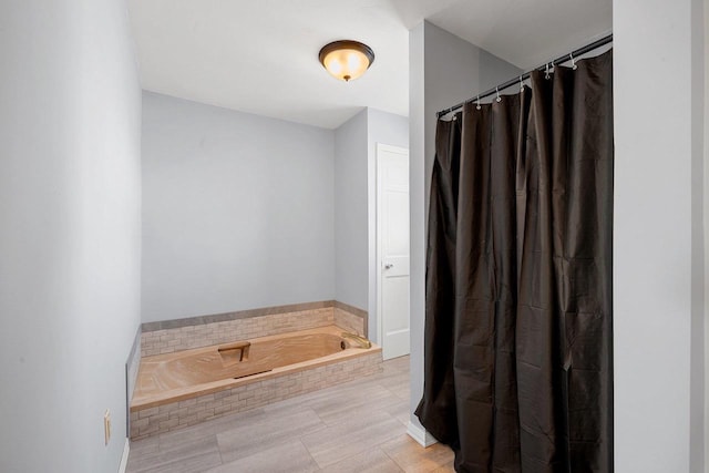 bathroom featuring tiled bath