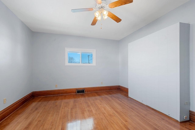 spare room with light hardwood / wood-style floors and ceiling fan