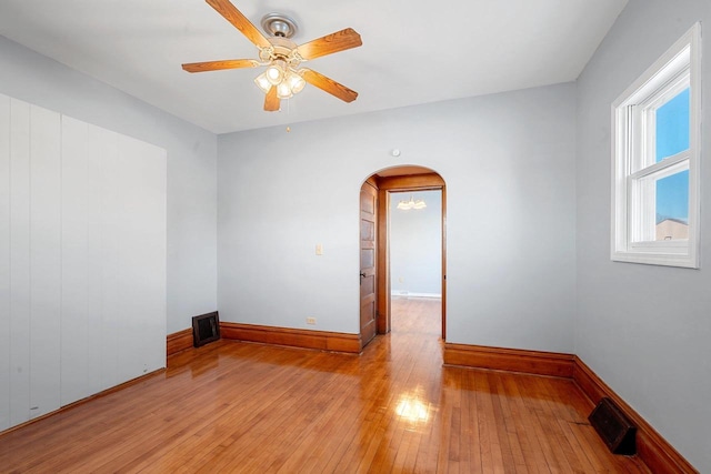 empty room featuring ceiling fan and light hardwood / wood-style floors