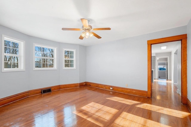 spare room featuring ceiling fan and light hardwood / wood-style flooring