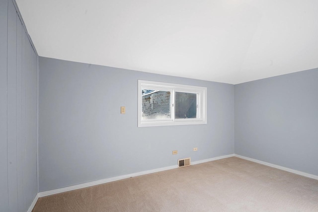 spare room featuring light colored carpet