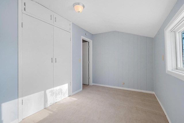 unfurnished bedroom featuring light carpet