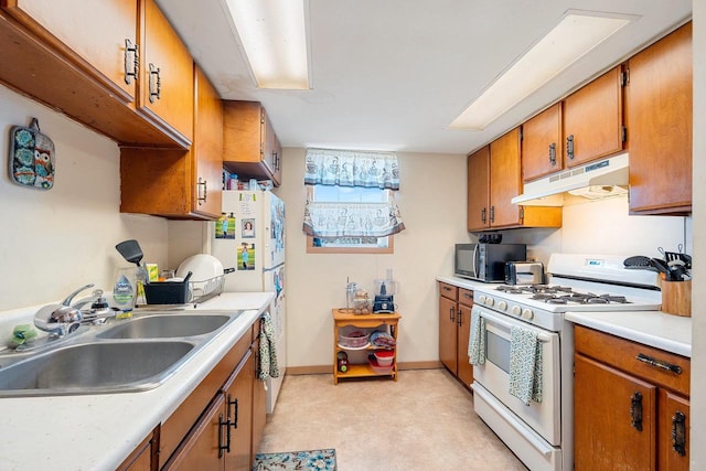 kitchen featuring sink and white range with gas stovetop