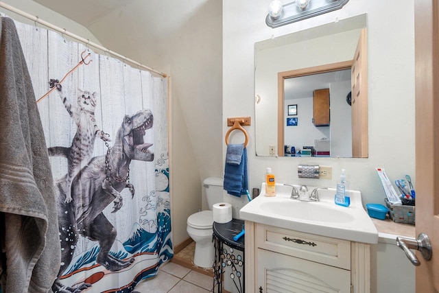 bathroom with lofted ceiling, toilet, vanity, and tile patterned flooring