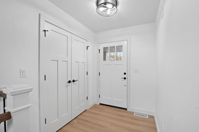 doorway to outside with light wood-type flooring