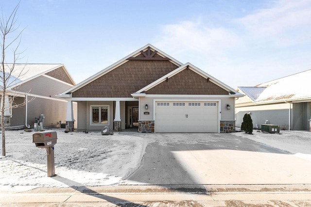 craftsman-style home featuring central AC and a garage