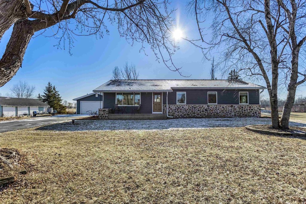 ranch-style house featuring a front lawn and a garage