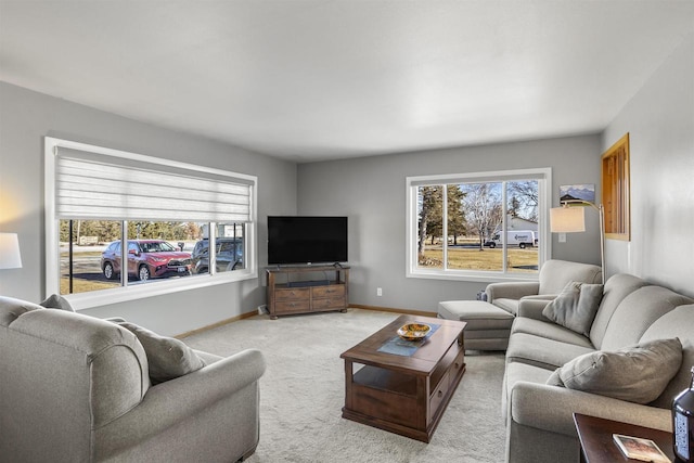 living room featuring a healthy amount of sunlight and light carpet