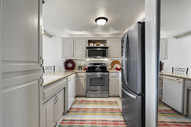 kitchen featuring appliances with stainless steel finishes, sink, and gray cabinets