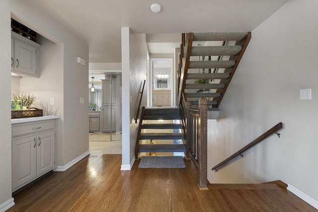 stairs with hardwood / wood-style floors