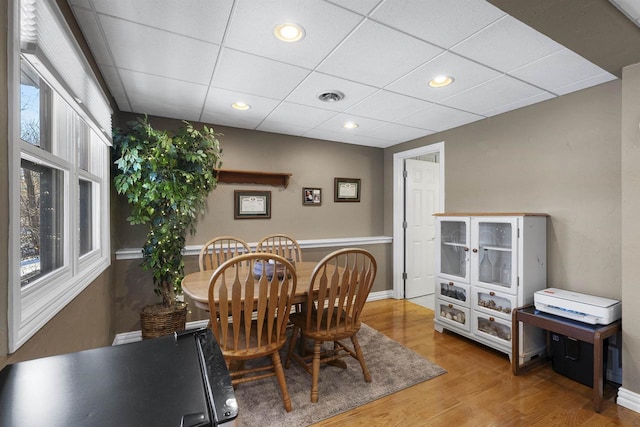 dining room featuring a paneled ceiling and hardwood / wood-style flooring