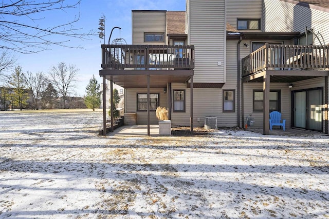 snow covered property with central AC