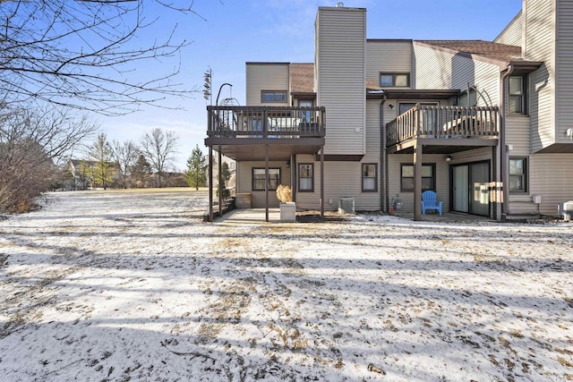 view of snow covered rear of property