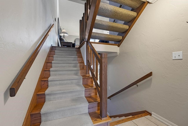 stairway with tile patterned flooring