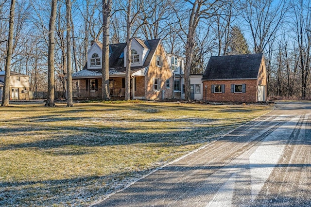 view of front facade with covered porch and a front yard