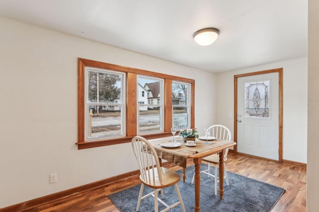 dining space with wood-type flooring