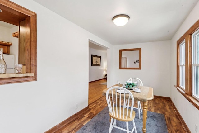 dining room with dark hardwood / wood-style floors