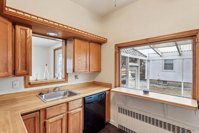 kitchen featuring baseboard heating, radiator heating unit, black dishwasher, and sink