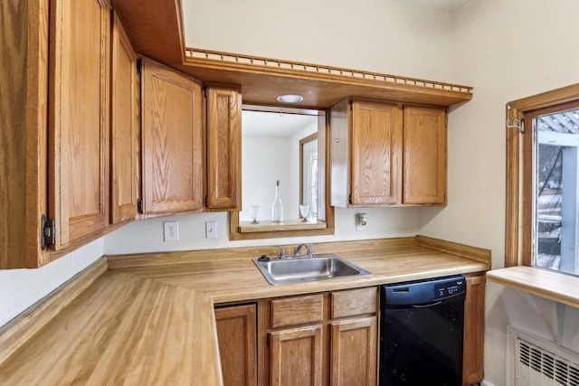 kitchen with radiator heating unit, black dishwasher, and sink