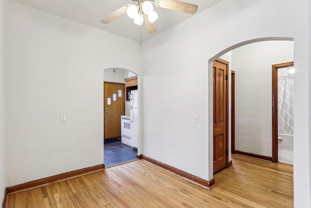 spare room featuring ceiling fan and light hardwood / wood-style floors