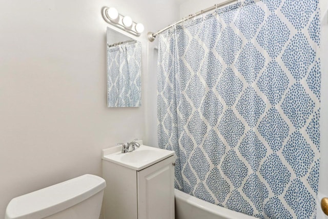 full bathroom featuring vanity, shower / tub combo, and toilet