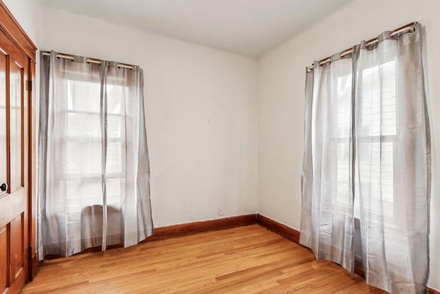 spare room with plenty of natural light and light wood-type flooring